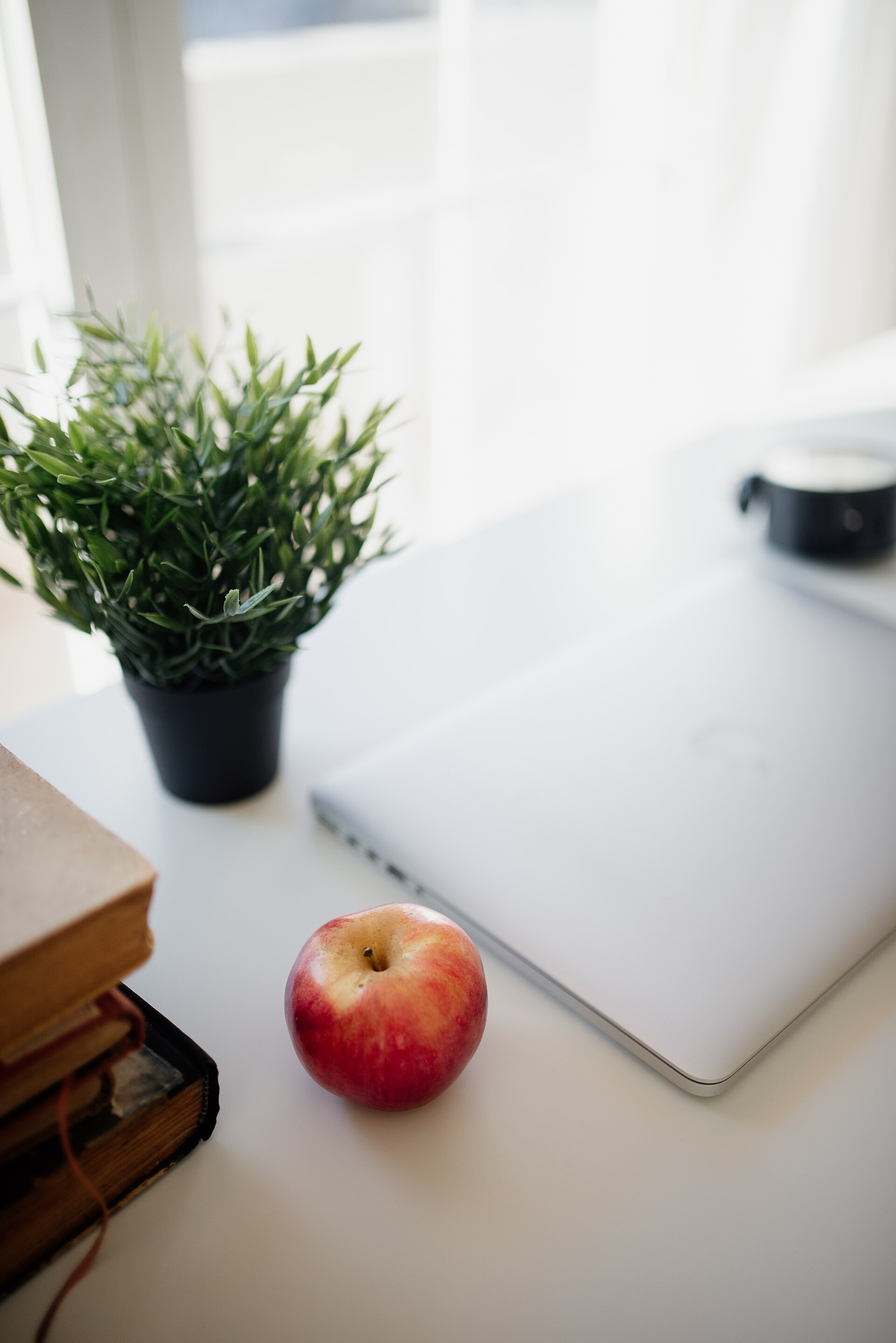 A bright, modern workspace with a laptop on a clean desk