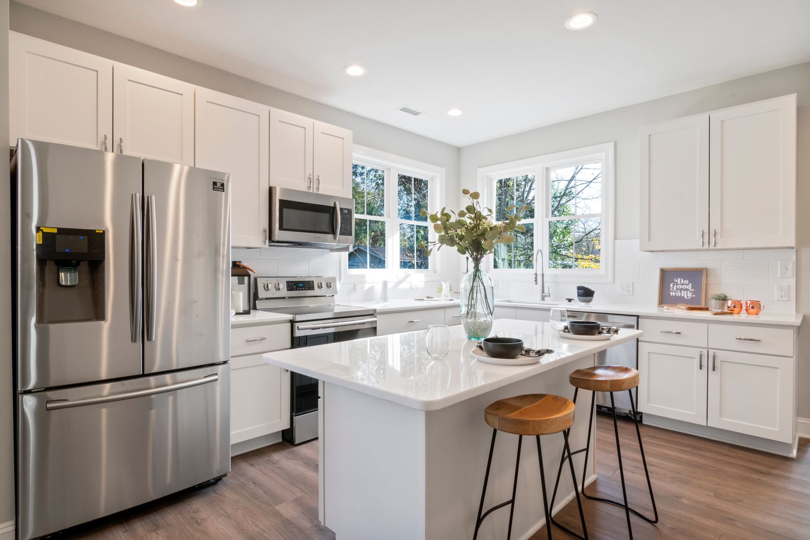 A modern kitchen with an island, showing cabinet colour and worktop choices