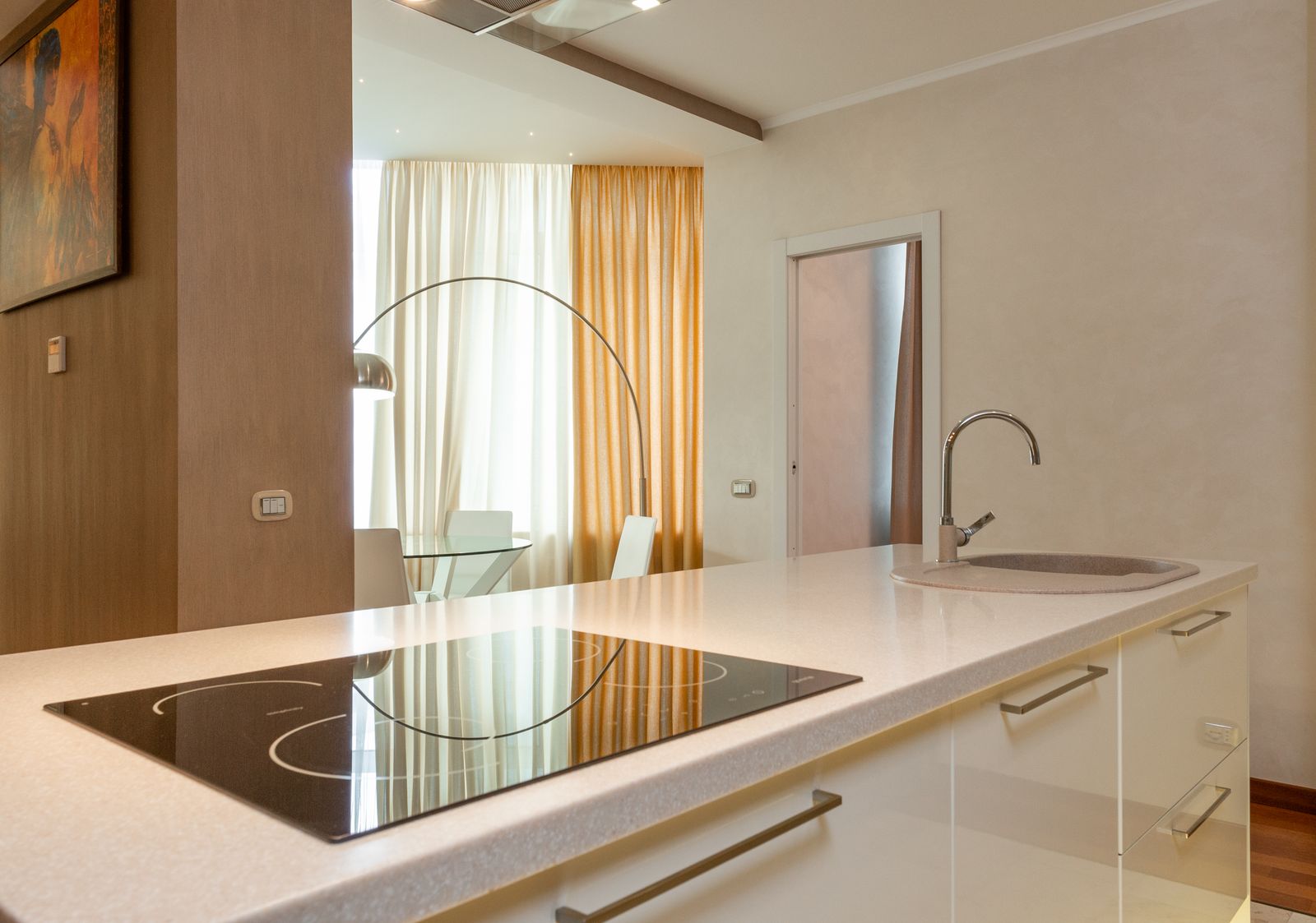 A bright modern kitchen with an island and pendant lighting