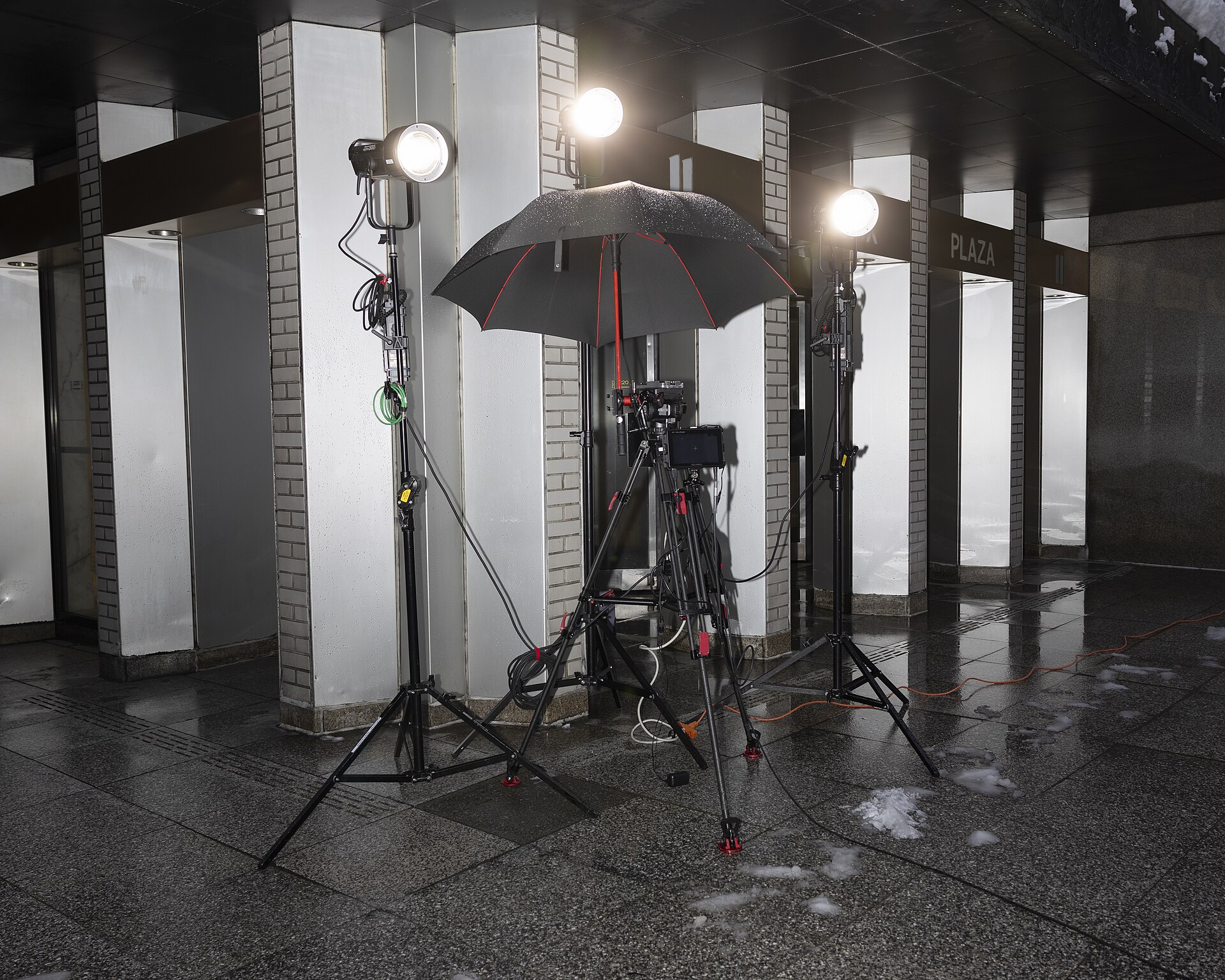 A professional video camera and lighting rig on a production set