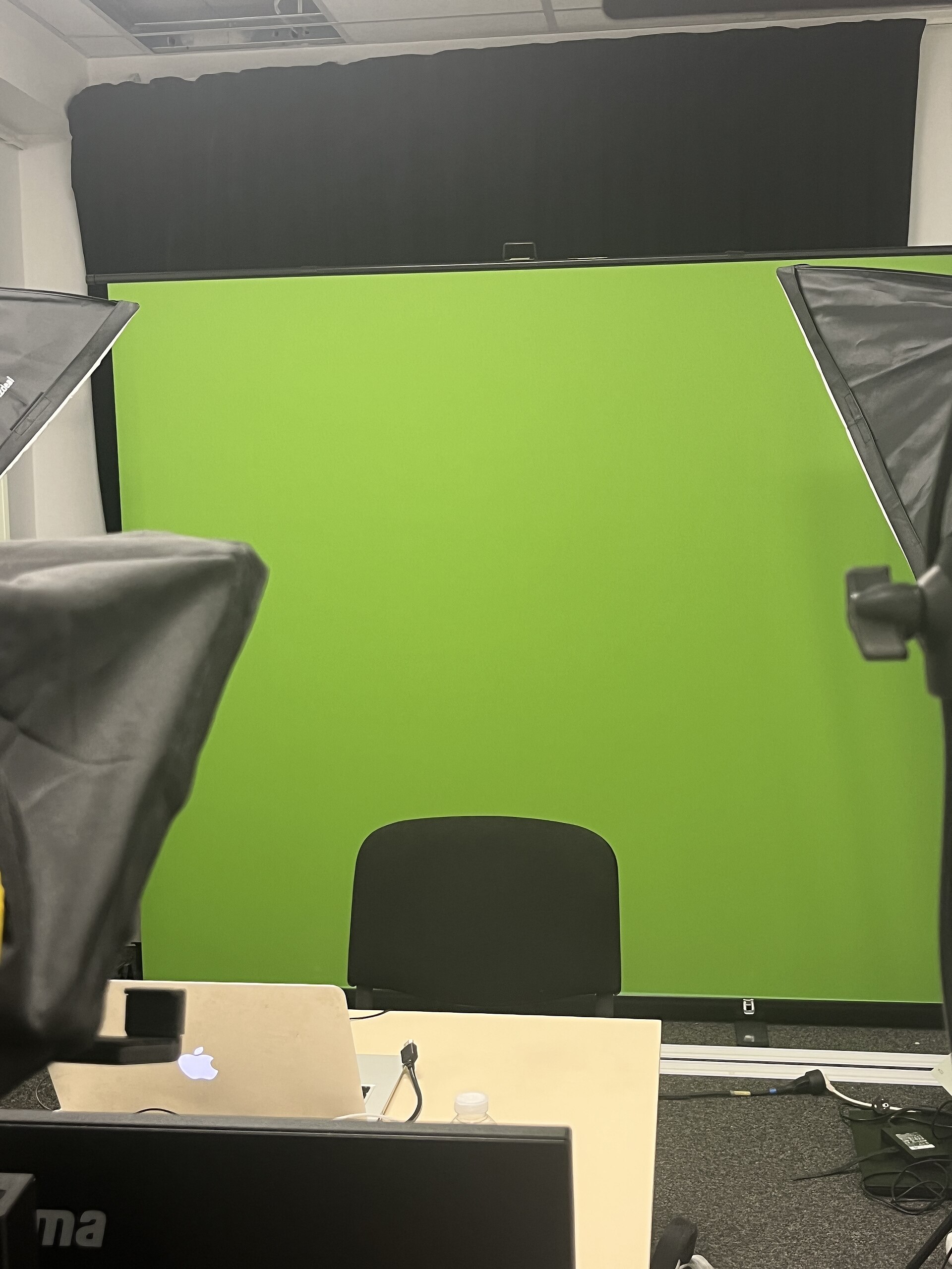 A video production studio with a green screen setup