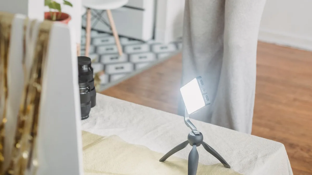 A real estate photographer with a professional camera shooting an apartment interior
