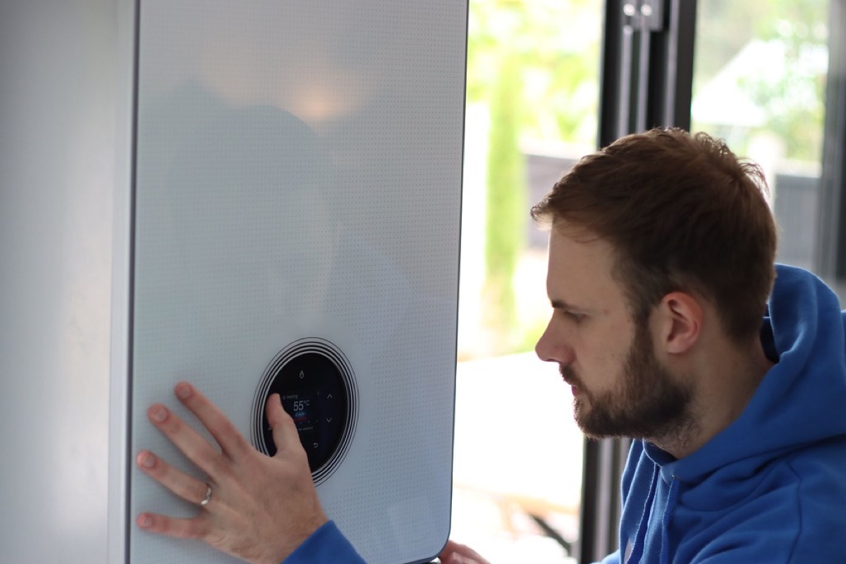 A tradesperson working on a combi boiler installation